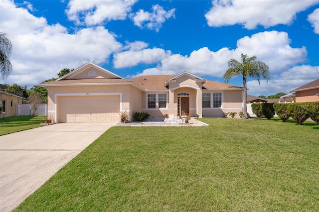 single story home with stucco siding, a front lawn, fence, concrete driveway, and an attached garage