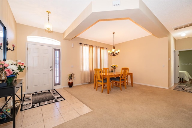 entryway featuring visible vents, light tile patterned floors, baseboards, light colored carpet, and a chandelier