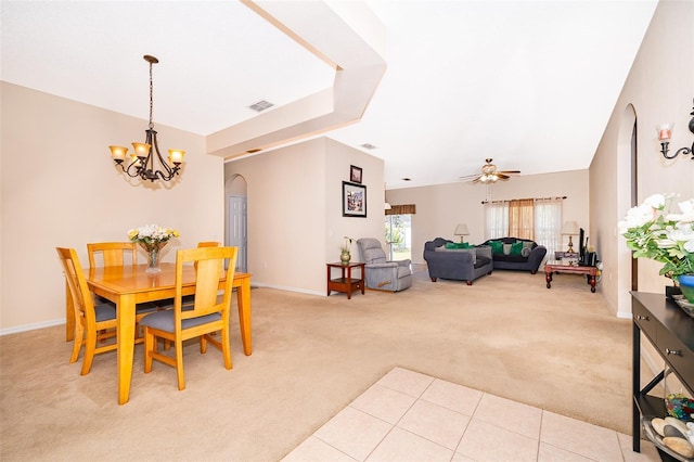 dining room with visible vents, arched walkways, light colored carpet, and baseboards