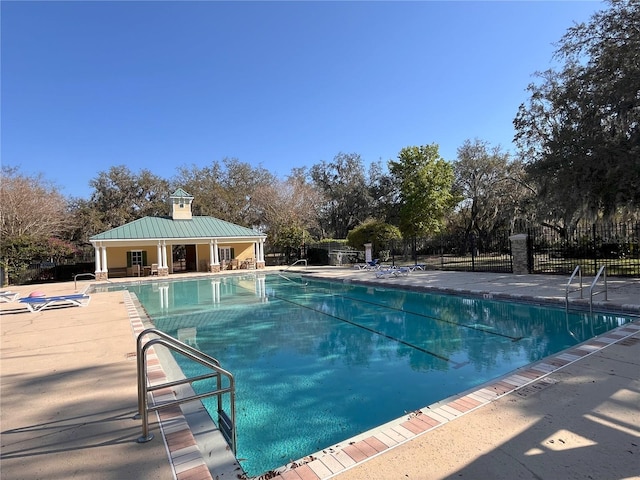 community pool featuring a patio and fence