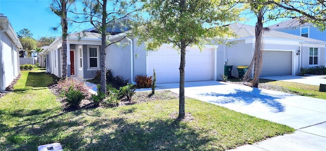 ranch-style home with a garage, concrete driveway, and stucco siding