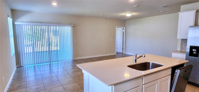 kitchen featuring light tile patterned floors, visible vents, a sink, light countertops, and appliances with stainless steel finishes