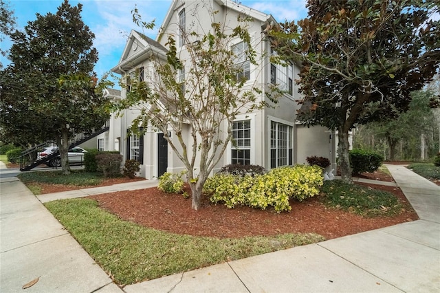 view of front of home featuring stucco siding and driveway