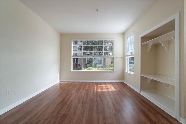 empty room featuring baseboards and wood finished floors