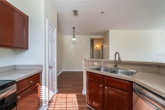 kitchen with visible vents, a sink, dark wood-style floors, light countertops, and dishwasher