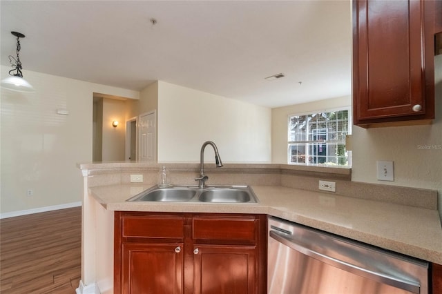 kitchen with visible vents, dishwasher, light countertops, and a sink