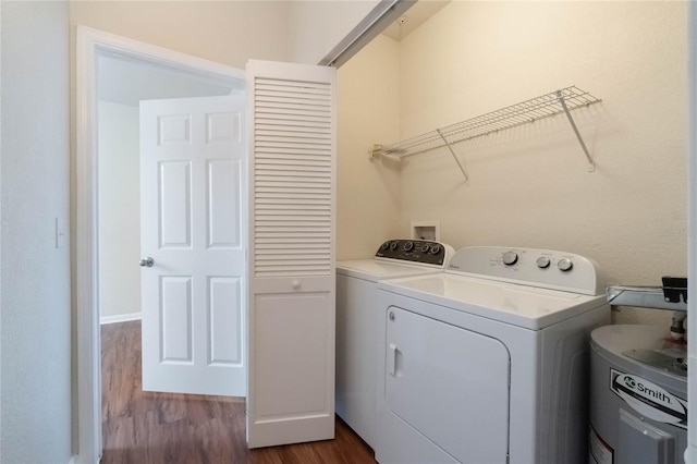 laundry area with washer and clothes dryer, laundry area, and dark wood finished floors