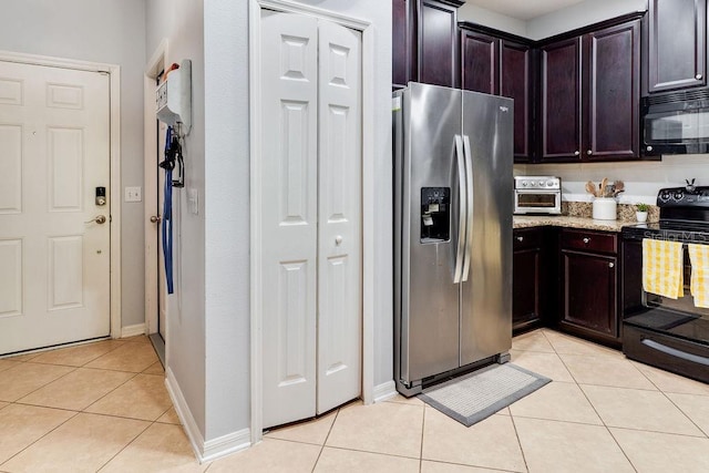 kitchen featuring light tile patterned flooring, dark brown cabinets, black appliances, and light stone counters