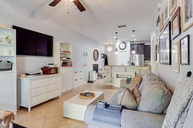 living room featuring ceiling fan, visible vents, and light tile patterned flooring