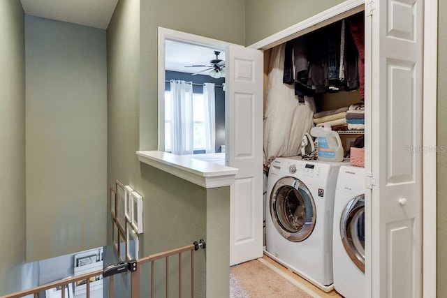 clothes washing area featuring laundry area, washer and dryer, and a ceiling fan