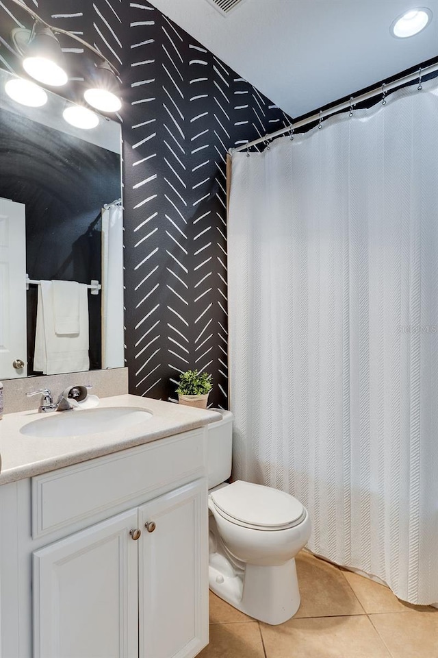 bathroom with tile patterned floors, curtained shower, toilet, and vanity