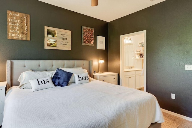 bedroom featuring ceiling fan, baseboards, carpet floors, and ensuite bath