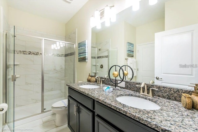 bathroom with a shower stall, toilet, and a sink