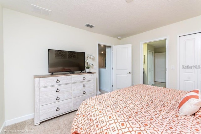 bedroom featuring visible vents, a textured ceiling, baseboards, and carpet floors