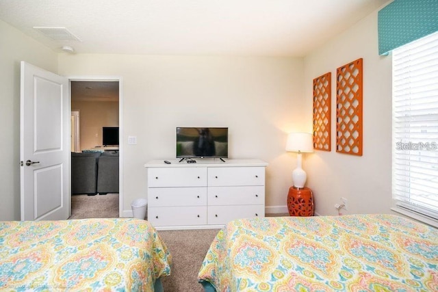 bedroom with visible vents and light colored carpet