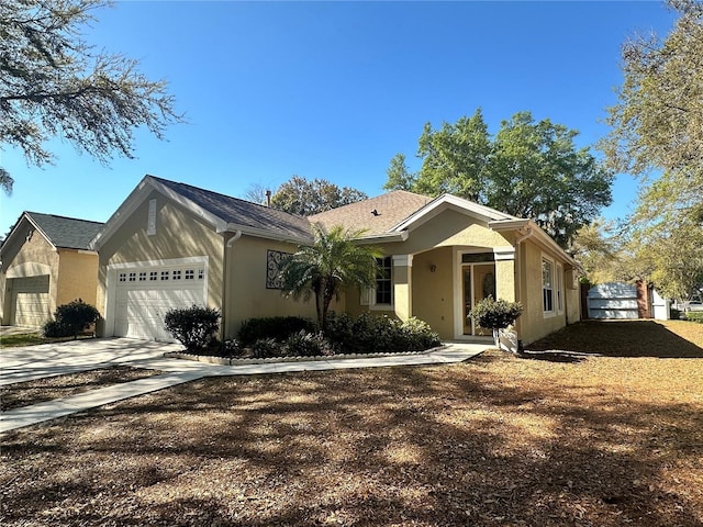 view of front of home featuring stucco siding, driveway, and an attached garage