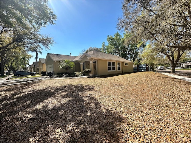 view of property exterior with stucco siding and an attached garage