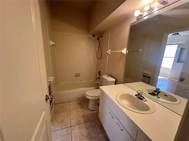 full bathroom featuring vanity, tile patterned floors, toilet, and shower / bathtub combination