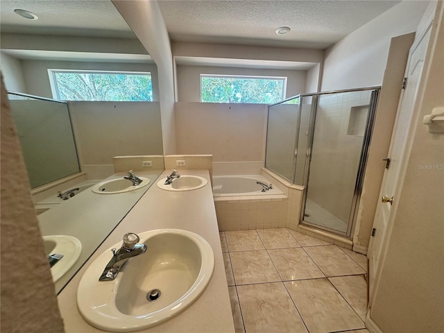 bathroom featuring a bath, a healthy amount of sunlight, and a sink