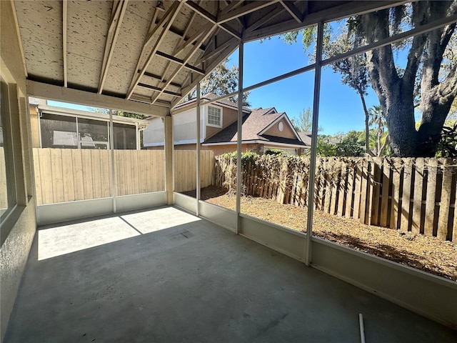 unfurnished sunroom featuring lofted ceiling