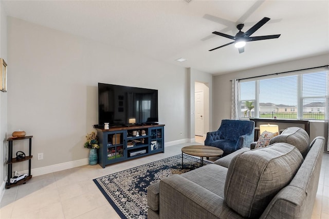 tiled living room with a ceiling fan and baseboards