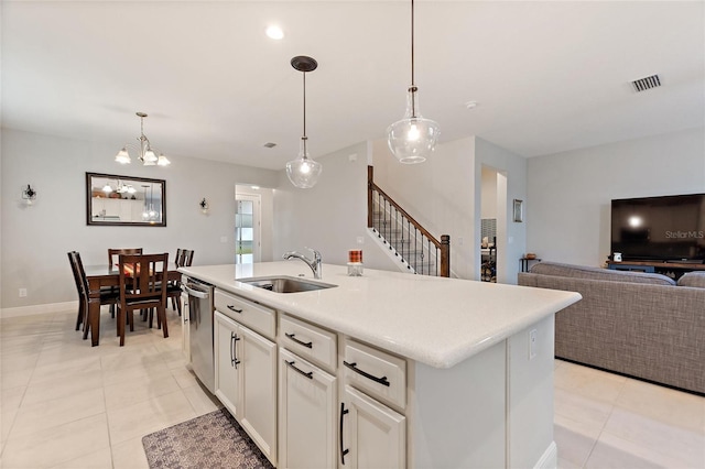 kitchen featuring visible vents, a sink, open floor plan, light countertops, and dishwasher