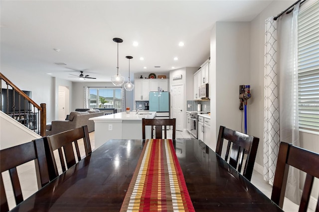 dining area with stairway, recessed lighting, and ceiling fan