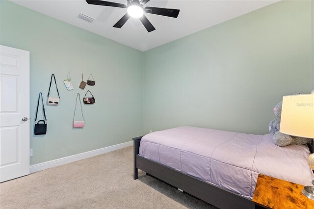 bedroom featuring visible vents, baseboards, carpet, and a ceiling fan