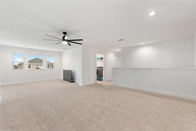 unfurnished living room featuring recessed lighting, light colored carpet, baseboards, and ceiling fan