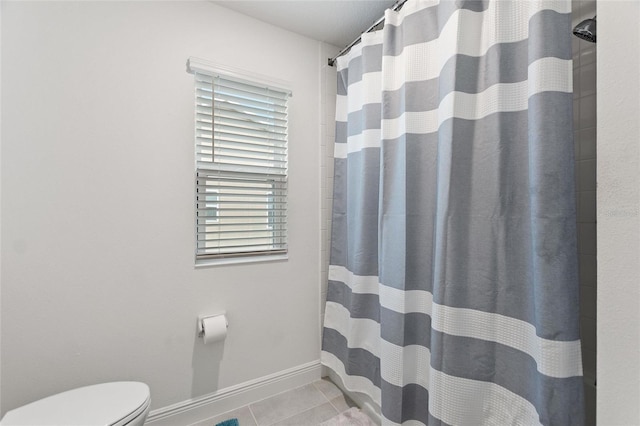 bathroom with tile patterned floors, baseboards, toilet, and a shower with shower curtain