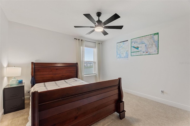 bedroom with light carpet, ceiling fan, and baseboards