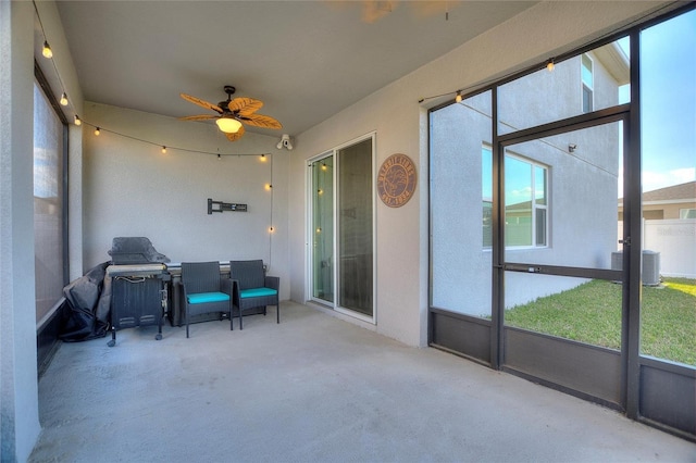 sunroom / solarium featuring ceiling fan