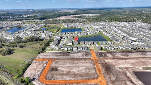 birds eye view of property featuring a water view and a residential view