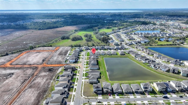 birds eye view of property featuring a water view and a residential view