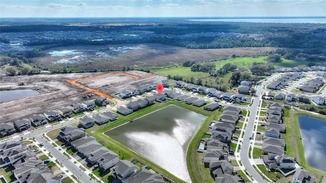 bird's eye view featuring a water view and a residential view