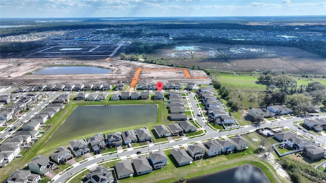 bird's eye view featuring a water view and a residential view