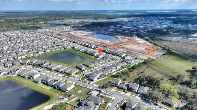 bird's eye view with a residential view and a water view