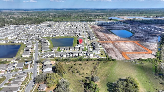 drone / aerial view featuring a water view and a residential view