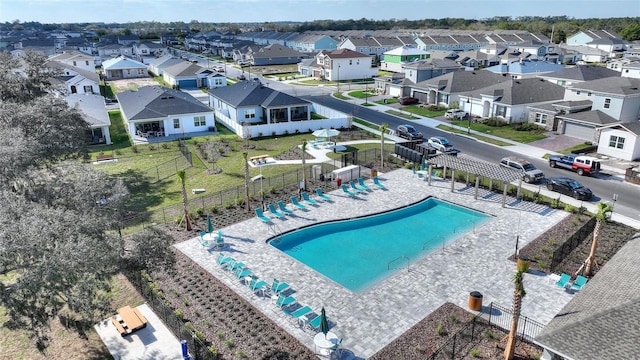 view of pool with a residential view and fence