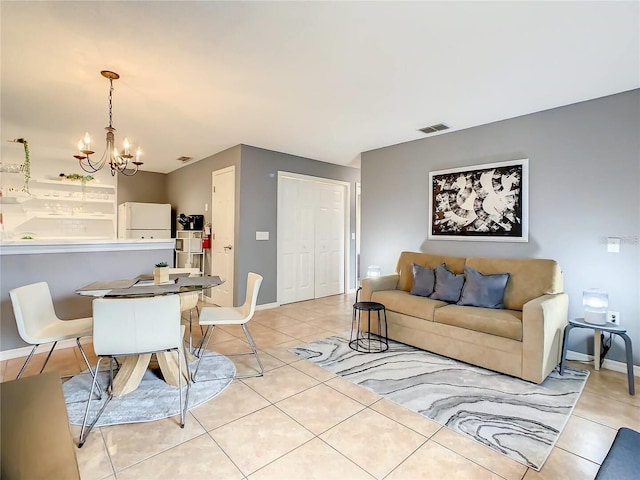 living area with light tile patterned floors, visible vents, baseboards, and a notable chandelier