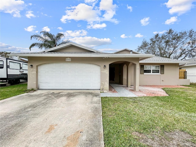 ranch-style house featuring stucco siding, driveway, a front lawn, fence, and a garage