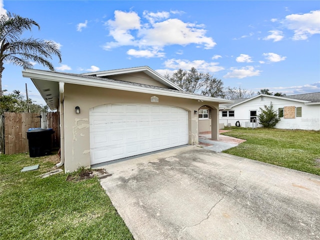 garage featuring fence and driveway