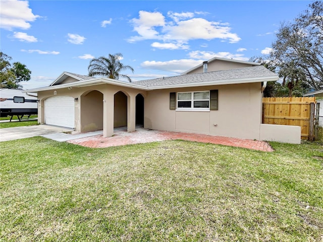 ranch-style house with a front lawn, fence, a garage, and stucco siding