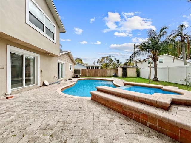 view of swimming pool featuring a fenced in pool, a shed, a fenced backyard, an outdoor structure, and a patio area