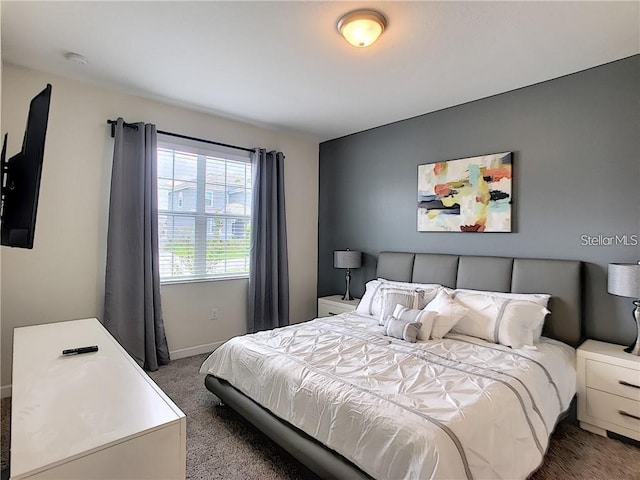 carpeted bedroom featuring baseboards