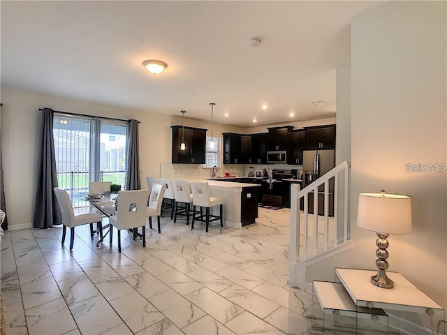 dining room with stairs, recessed lighting, marble finish floor, and baseboards