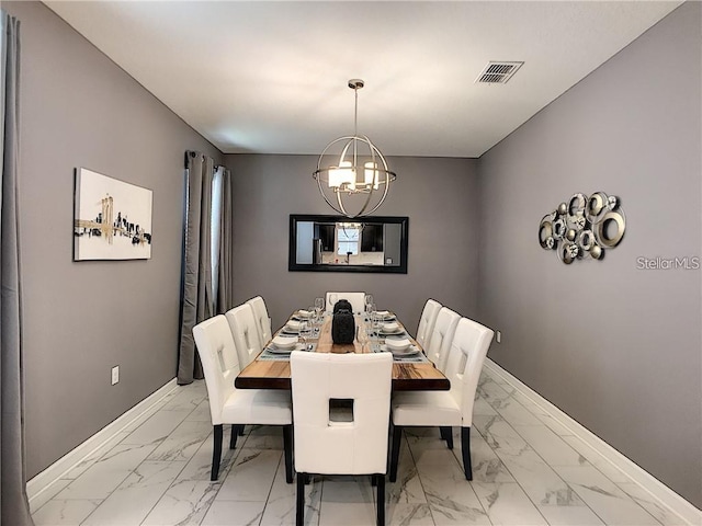 dining room featuring baseboards, marble finish floor, and an inviting chandelier