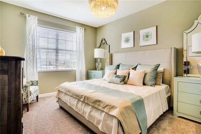 bedroom featuring baseboards and carpet