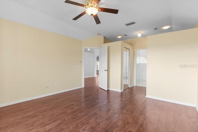 unfurnished room featuring visible vents, a textured ceiling, wood finished floors, baseboards, and ceiling fan