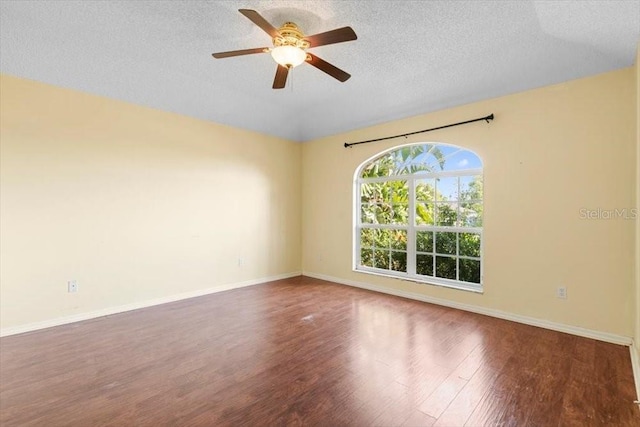 spare room featuring a textured ceiling, baseboards, a ceiling fan, and wood finished floors